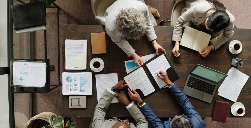 Collega’s bespreken documenten aan een vergadertafel